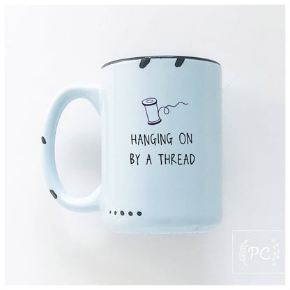 Hanging on by a thread | ceramic mug: Green