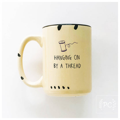 Hanging on by a thread | ceramic mug: Green