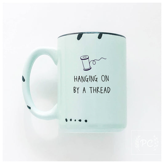 Hanging on by a thread | ceramic mug: Green