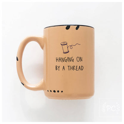 Hanging on by a thread | ceramic mug: Green