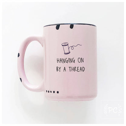 Hanging on by a thread | ceramic mug: Green